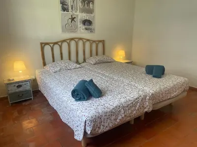 a bedroom with a bed with two blue pillows on it at Luxury Villa private pool, Albufeira in Albufeira