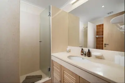 a bathroom with a sink and a shower at 3 bedroom Vila Sol Golf Resort- 1st Floor in Quarteira