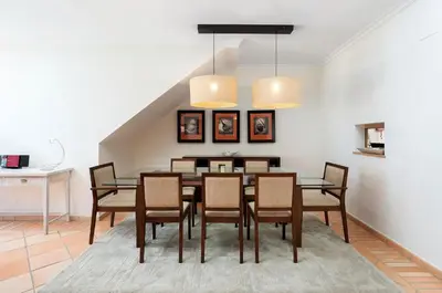 a dining room with a table and chairs at 3 bedroom Vila Sol Golf Resort- 1st Floor in Quarteira