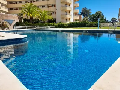 a large blue swimming pool in front of a building at Marina Mar Bela Vista by SAPvillas in Vilamoura