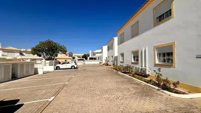 a car parked in a parking lot next to a building at Casa Vela São Rafael in Albufeira