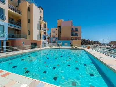 a swimming pool in the middle of a building at Luxury 1 Bedroom Apartment, Marina de Albufeira4 in Albufeira