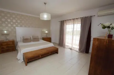 a bedroom with a bed and a large window at Villa Perla in Guia
