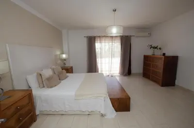 a bedroom with a bed and a dresser and a window at Villa Perla in Guia