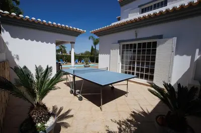 a ping pong table in the courtyard of a house at Villa Perla in Guia