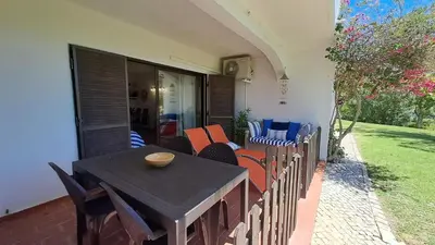 a wooden table and chairs on a patio at SÃO RAFAEL BEACH Apartment 55 in Albufeira
