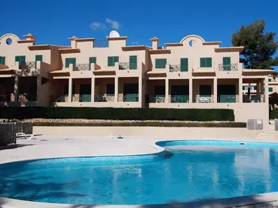 a large building with a pool in front of it at Charming Villa Albufeira in Albufeira