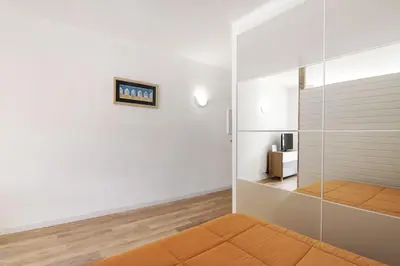 a room with a glass partition with a bed and a television at Sun and Serenity in Albufeira