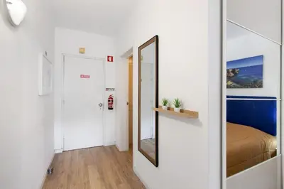 a small hallway with a mirror and a bed at Sun and Serenity in Albufeira