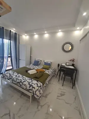 a bedroom with a bed and a desk in it at Albufeira studio in Albufeira