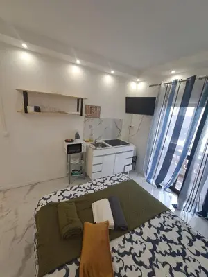 a small bedroom with a bed and a desk at Albufeira studio in Albufeira