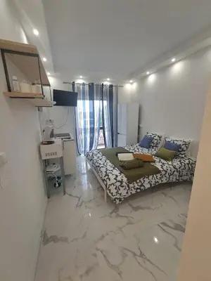a bedroom with a bed and a desk in it at Albufeira studio in Albufeira