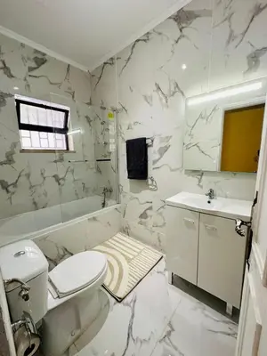 a white bathroom with a toilet and a sink at Albufeira studio in Albufeira