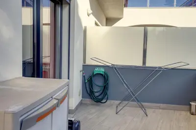 a kitchen with a hose hooked up to a refrigerator at Modern Vacation Home With Pool In Quarteira in Quarteira