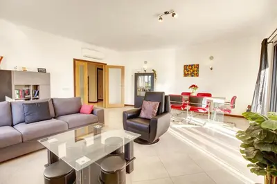 a living room with a couch and a table at Modern Vacation Home With Pool In Quarteira in Quarteira