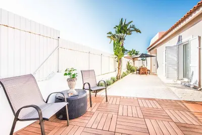a patio with two chairs and a table on a building at Casa Alfazema in Albufeira