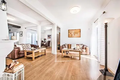 a living room with a couch and a table at Casa Alfazema in Albufeira
