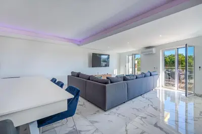 a living room with a couch and a table at Apart OCEAN DRIVE - Oura - Jacuzzi - BY BEDZY in Albufeira