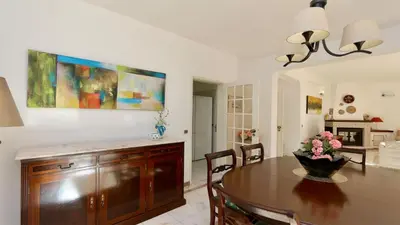 a kitchen and dining room with a wooden table at Villa Den, private pool villa, Sleeps 6 adults and 2 children, CD 304 - Cleverdetails in Vilamoura