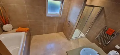 a bathroom with a shower and a toilet and a sink at Villa Cristina in Quarteira
