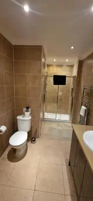 a bathroom with a toilet and a shower and a sink at Villa Cristina in Quarteira