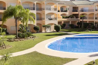 a resort with a swimming pool in front of a building at Praia Village I - Peaceful condominium by HD in Vilamoura