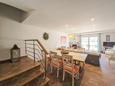 a dining room with a table with a vase on it at Holiday Home V3 Falésia - Vip Properties by Interhome in Roja- Pé