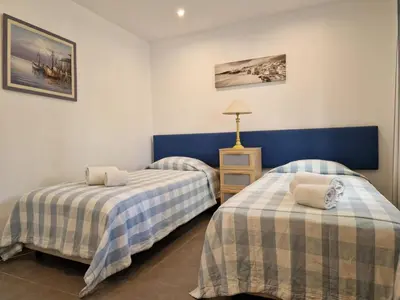 a bedroom with a bed with hats and shoes on it at Holiday Home V3 Falésia - Vip Properties by Interhome in Roja- Pé