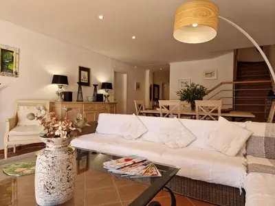 a living room with a white couch and a fireplace at Holiday Home V3 Falésia - Vip Properties by Interhome in Roja- Pé