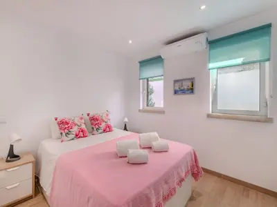 a bedroom with two beds and a window at Apartment T3 capricórnio - VIP Properties by Interhome in Galé