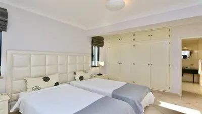a bedroom with a white bed and a balcony at Villa Linda Rosa, CD 302 by Cleverdetails private pool, prime location in Vilamoura