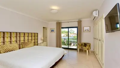 a patio with a table and chairs on a balcony at Villa Linda Rosa, CD 302 by Cleverdetails private pool, prime location in Vilamoura