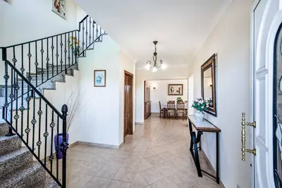 a hallway of a home with stairs and a table at Villa Agapito in Terras Novas