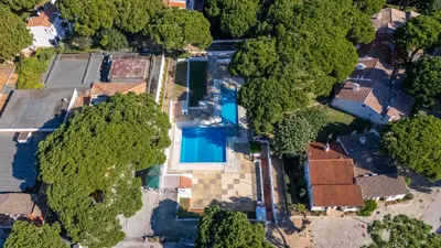an overhead view of a house with a swimming pool and trees at Açoteias Studio w Pool by LovelyStay in Albufeira