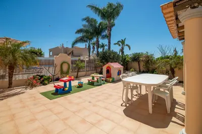 a bedroom with a bed with two towels on it at Casa Laranjal in Albufeira