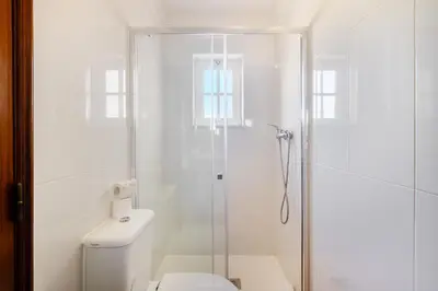 a bathroom with a sink and a mirror at Ponta Grande Resort - Villa Dourada in Albufeira