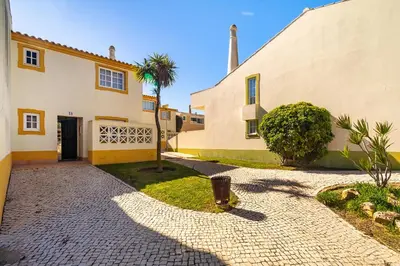 a patio with a couch on a wall at Ponta Grande Resort - Villa Dourada in Albufeira