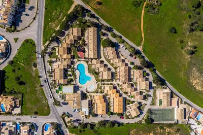an aerial view of a resort near the ocean at Ponta Grande Resort - Villa Dourada in Albufeira