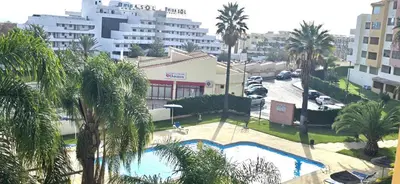 an overhead view of a pool with palm trees and buildings at Centre View in Albufeira