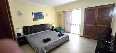 a bedroom with a bed with two bags on it at Centre View in Albufeira