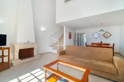 a kitchen with white cabinets and a microwave at Ponta Grande Resort - Villa Ponta in Albufeira