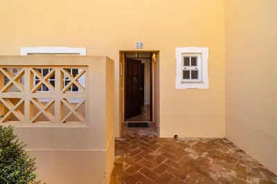 two beds in a white room with a window at Ponta Grande Resort - Villa Ponta in Albufeira