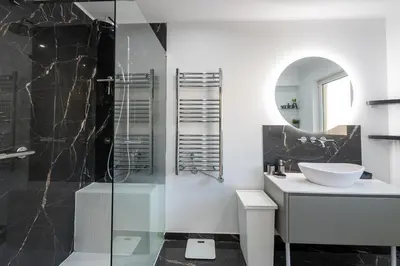 a bathroom with a sink and a glass shower at Villa Louanna in Vilamoura