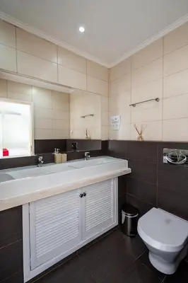 a bathroom with a sink and a toilet at Villa Louanna in Vilamoura