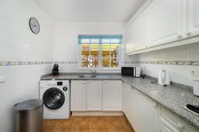 a kitchen with a washing machine and a sink at Ponta Grande Resort - Villa Atlântica in Albufeira
