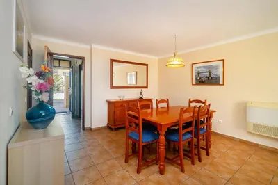 a kitchen and dining room with a table and chairs at Ponta Grande Resort - Villa Atlântica in Albufeira