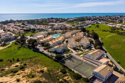 an aerial view of a house with a tennis court at Ponta Grande Resort - Villa Atlântica in Albufeira