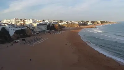 a view of a beach with chairs and the ocean at Pórtico de Malpique in Albufeira
