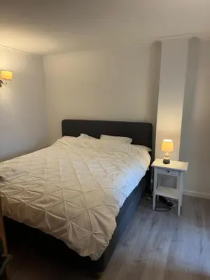 a bedroom with a bed and a side table at Casa Estrelinha Vilamoura in Quarteira