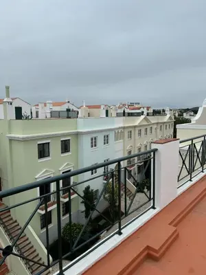 a balcony with a view of a building at Casa Estrelinha Vilamoura in Quarteira